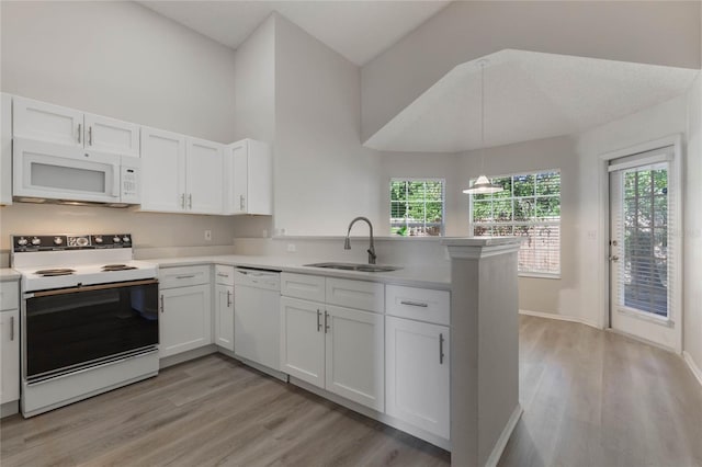 kitchen featuring white cabinets, a healthy amount of sunlight, and white appliances