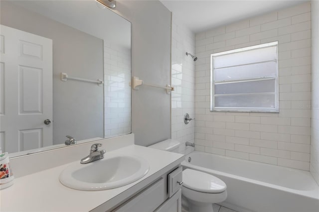 full bathroom with vanity, tiled shower / bath combo, and toilet