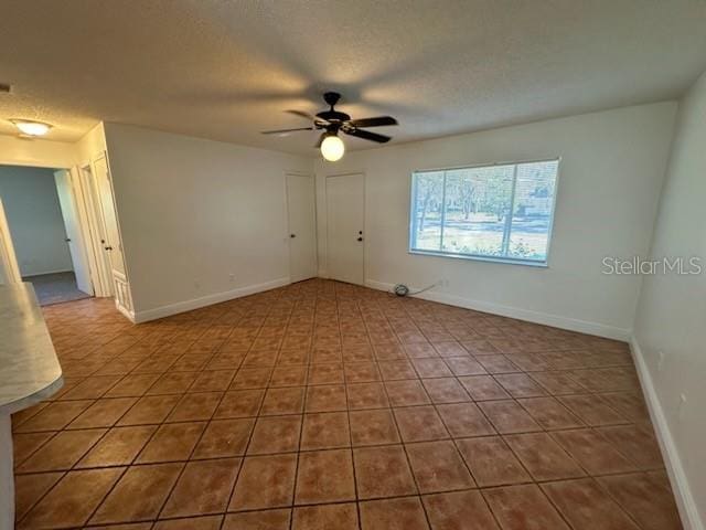4518 Watch Hill Rd, Orlando, FL 32808 - unfurnished room featuring ceiling fan, tile patterned flooring, and a textured ceiling