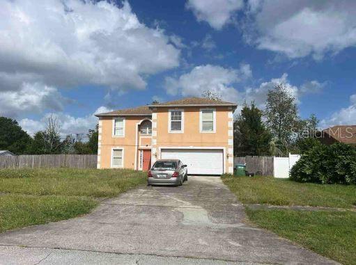 view of front facade with a front lawn and a garage