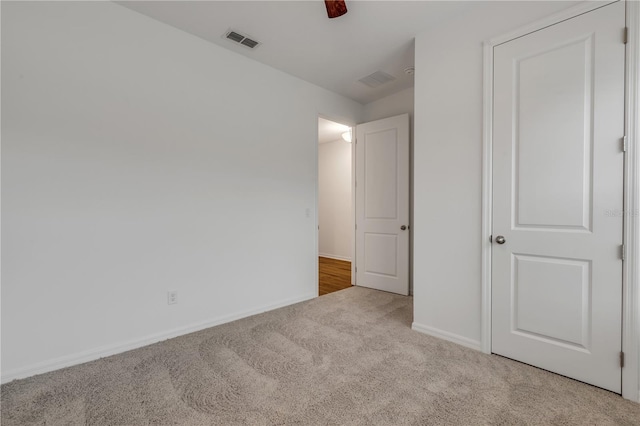 unfurnished bedroom featuring ceiling fan and light colored carpet