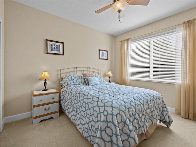 bedroom featuring ceiling fan and light colored carpet