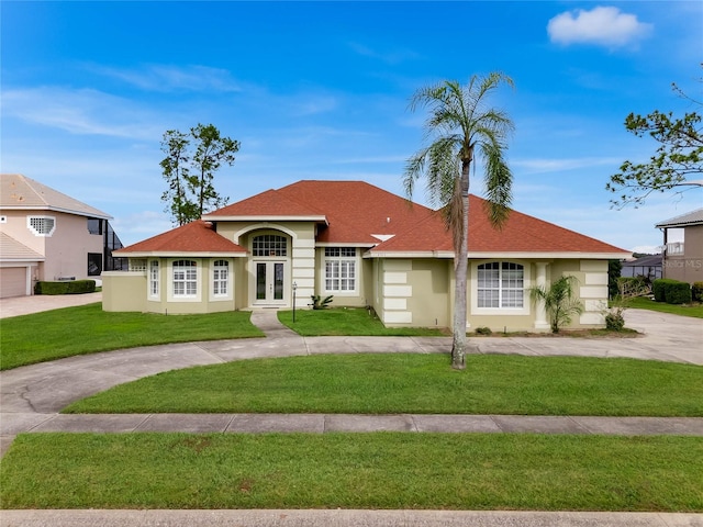 single story home with a front yard and french doors