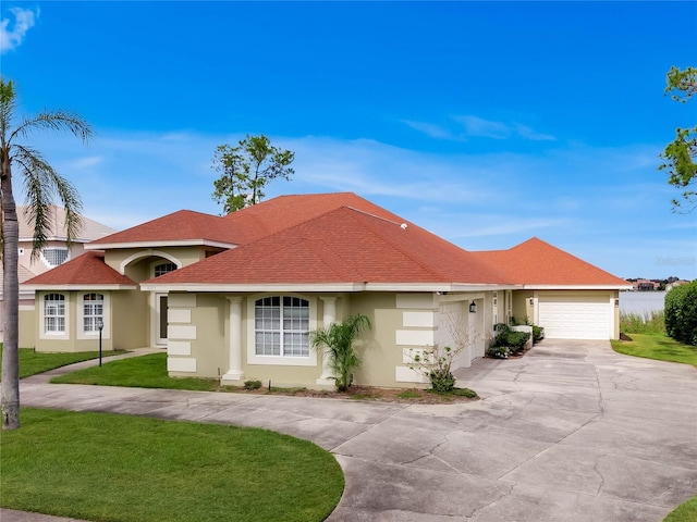 single story home featuring a garage and a front lawn