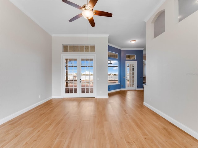 unfurnished living room featuring french doors, light hardwood / wood-style floors, ceiling fan, and crown molding