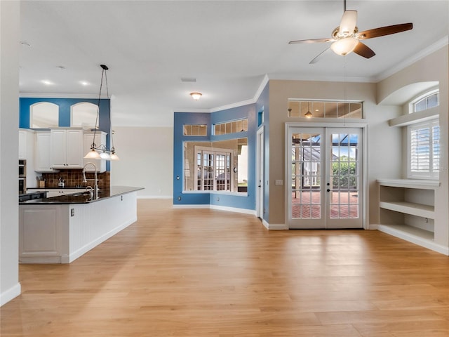 living room with french doors, sink, ceiling fan, ornamental molding, and light hardwood / wood-style floors