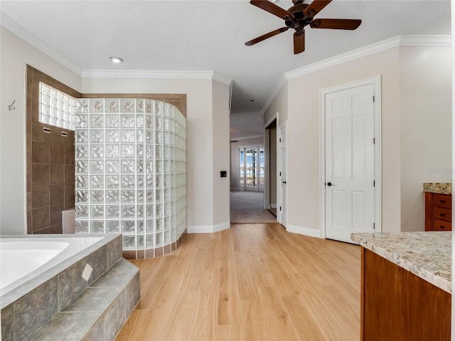 bathroom with hardwood / wood-style flooring, plenty of natural light, ornamental molding, and vanity