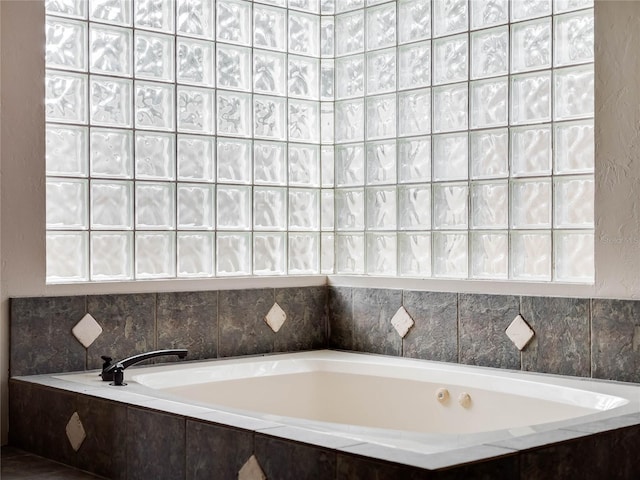 bathroom featuring a relaxing tiled tub