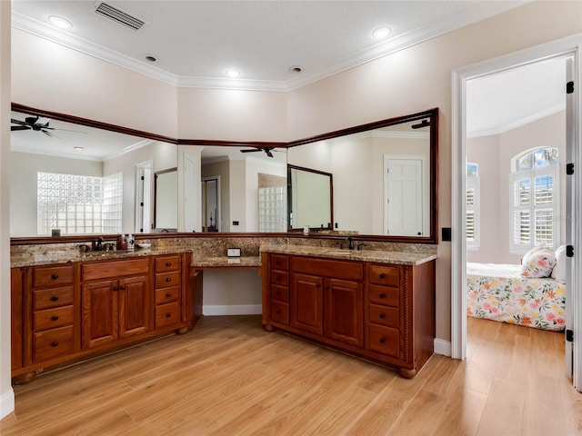 bathroom featuring hardwood / wood-style floors, vanity, and crown molding