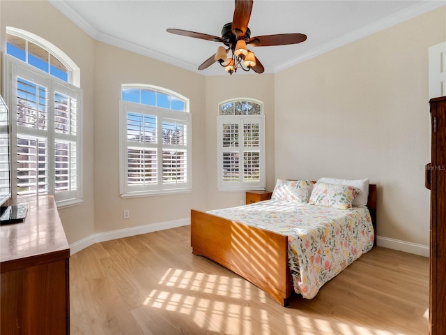 bedroom featuring ceiling fan, ornamental molding, and light hardwood / wood-style flooring