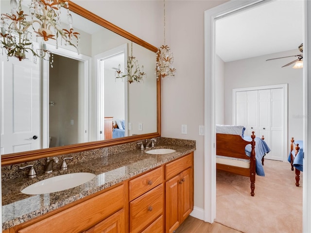 bathroom featuring ceiling fan, hardwood / wood-style floors, and vanity