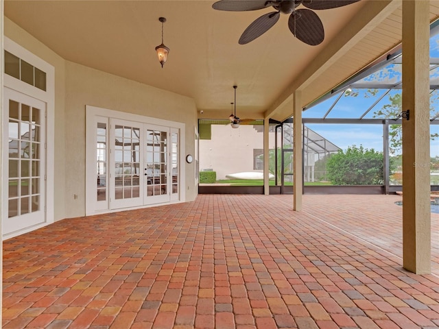 view of patio / terrace featuring ceiling fan, a lanai, and french doors