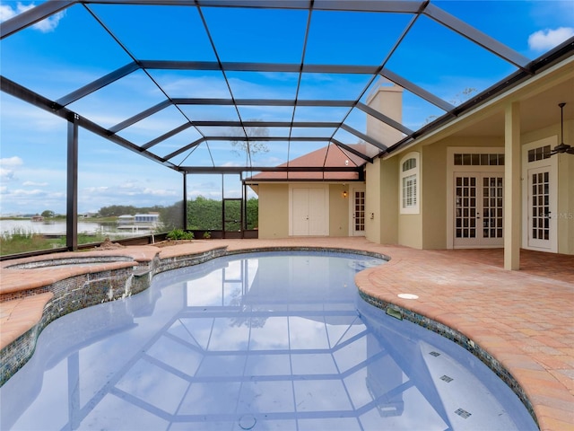 view of swimming pool with an in ground hot tub, french doors, a patio area, and a lanai