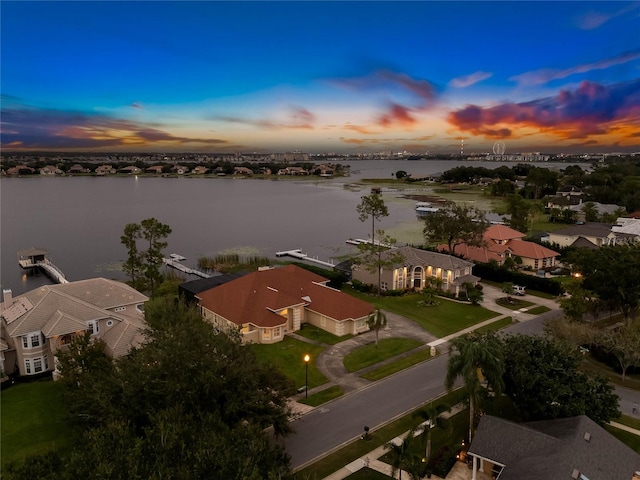 aerial view at dusk with a water view