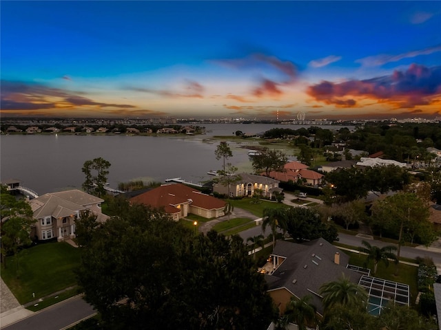 aerial view at dusk with a water view