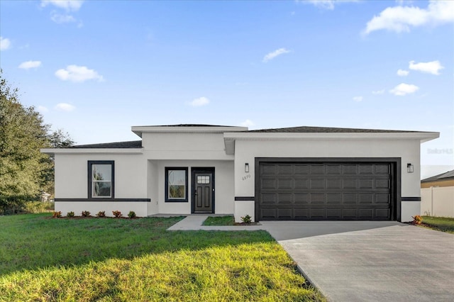 view of front of home featuring a front lawn and a garage