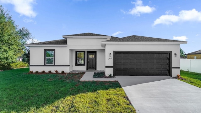 prairie-style house featuring a garage and a front yard