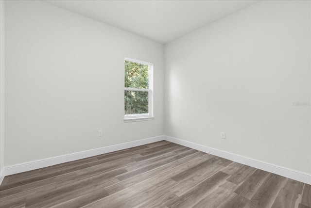 spare room with dark wood-type flooring