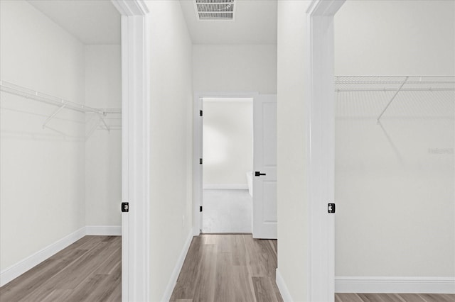 spacious closet featuring light hardwood / wood-style flooring