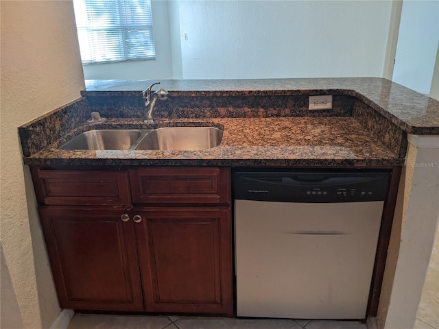 kitchen featuring kitchen peninsula, sink, white dishwasher, and light tile patterned flooring