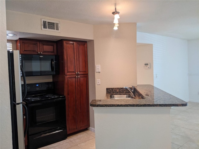 kitchen featuring sink, kitchen peninsula, a textured ceiling, light tile patterned flooring, and black appliances