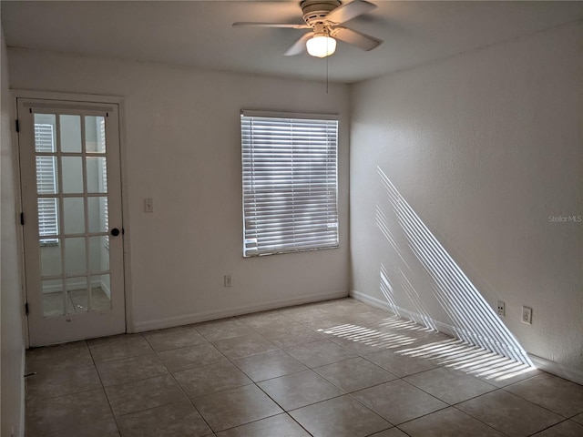 empty room featuring ceiling fan and light tile patterned flooring