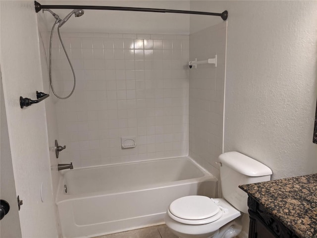 full bathroom featuring tile patterned flooring, vanity, toilet, and tiled shower / bath combo