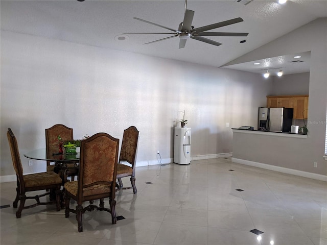 dining room featuring a textured ceiling, water heater, ceiling fan, and vaulted ceiling