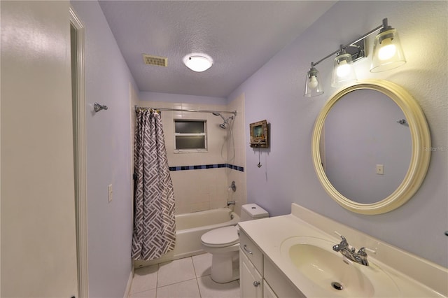 full bathroom featuring vanity, tile patterned floors, shower / bath combination with curtain, toilet, and a textured ceiling