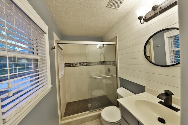 bathroom with wood walls, a shower with door, and toilet