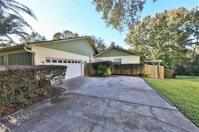 view of front of property with a front lawn and a garage