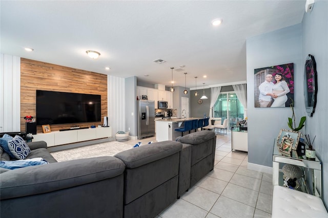 tiled living room with sink and wooden walls