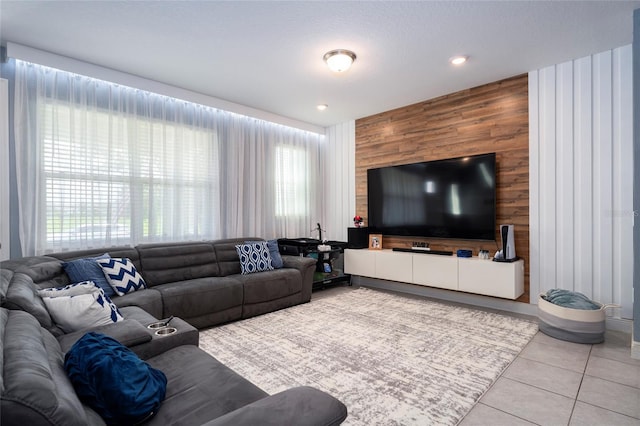 tiled living room with a wealth of natural light, wooden walls, and a textured ceiling