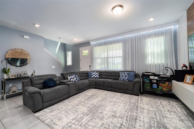 tiled living room with a textured ceiling