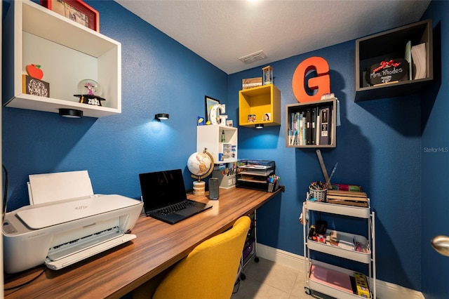 tiled home office featuring a textured ceiling