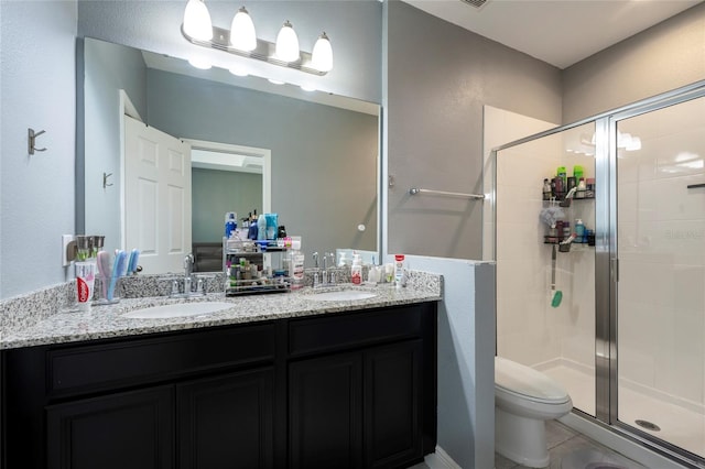 bathroom featuring tile patterned floors, vanity, toilet, and an enclosed shower