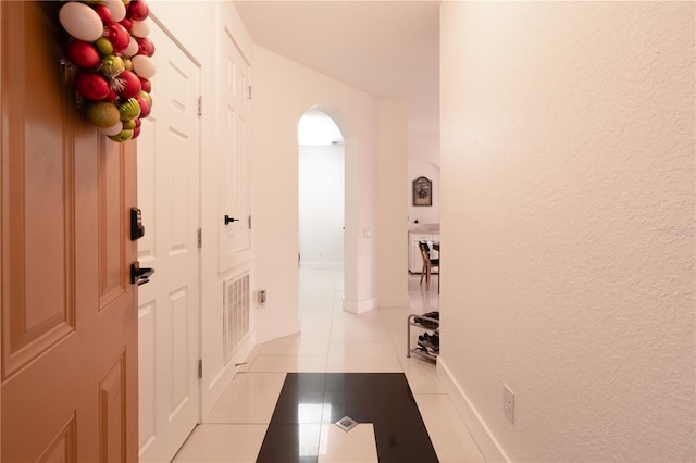 hall featuring light tile patterned floors