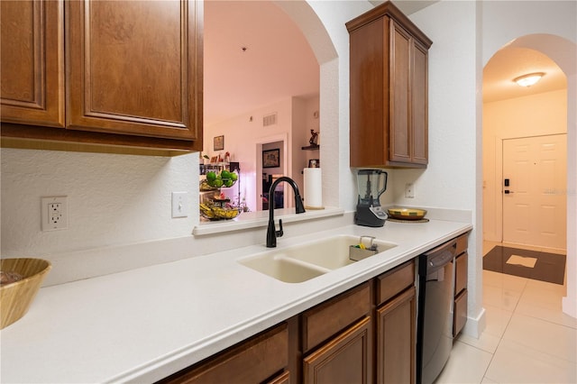 kitchen with dishwasher, light tile patterned flooring, and sink