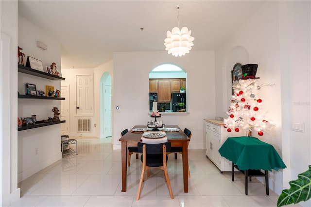 tiled dining space with an inviting chandelier