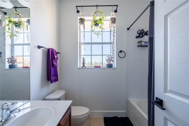 full bathroom featuring tile patterned flooring, vanity, toilet, and tiled shower / bath combo