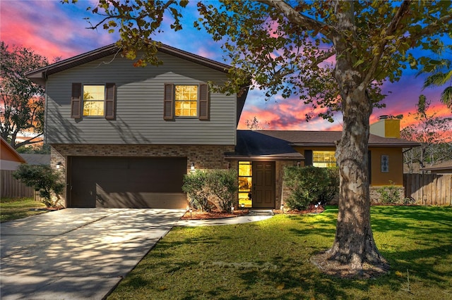 view of front of home with a yard and a garage