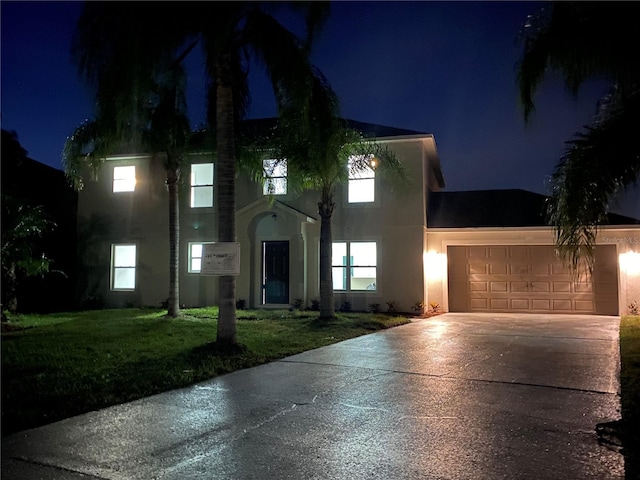 view of front facade with a lawn and a garage