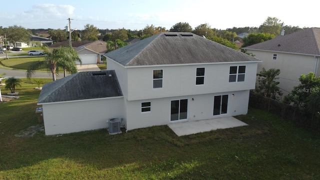 rear view of house featuring a lawn, a patio area, and central AC unit