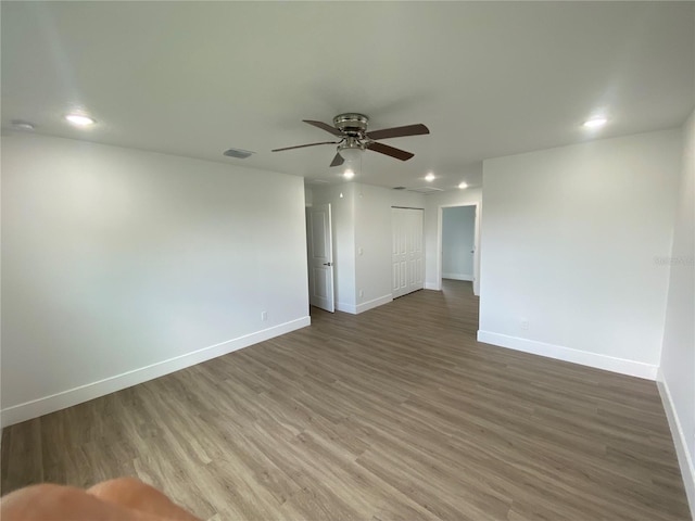 spare room featuring hardwood / wood-style floors and ceiling fan