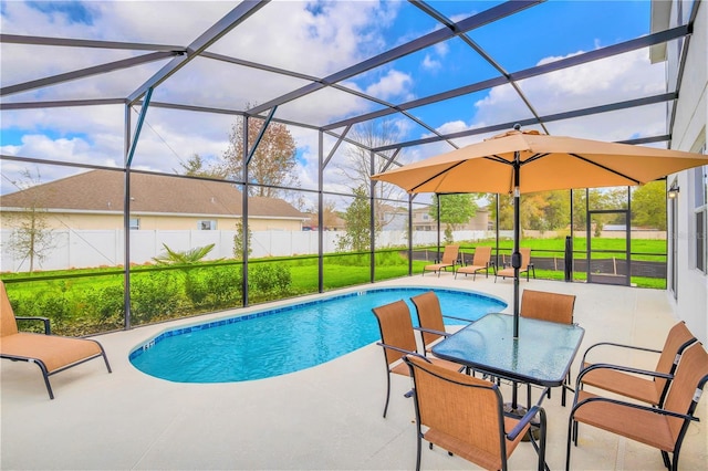 view of swimming pool featuring a lanai, a patio area, and a yard