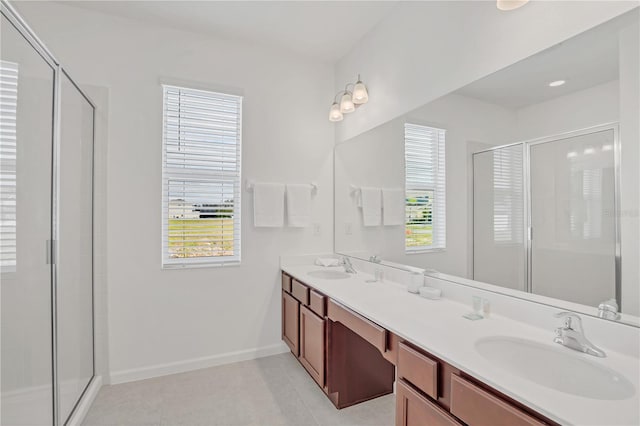 bathroom with tile patterned floors, vanity, and walk in shower