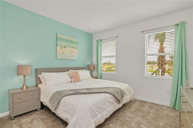 carpeted bedroom with multiple windows