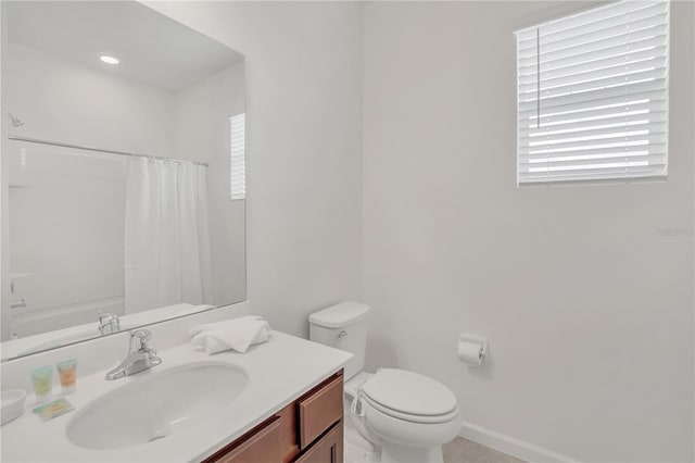 full bathroom with vanity, shower / tub combo, and toilet