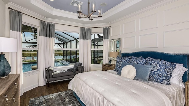 851 Arbor Green Trl, Saint Cloud, FL 34771 - bedroom with a chandelier, crown molding, dark wood-type flooring, and a raised ceiling