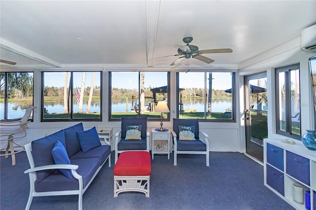 sunroom / solarium featuring a water view and ceiling fan